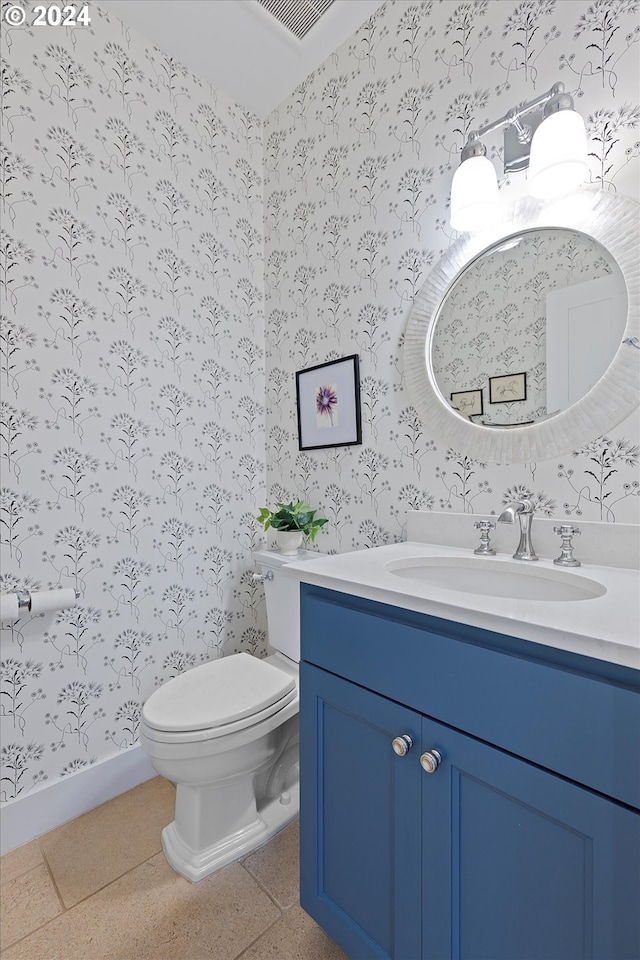 bathroom featuring toilet, tile patterned flooring, and vanity