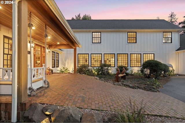 view of back house at dusk