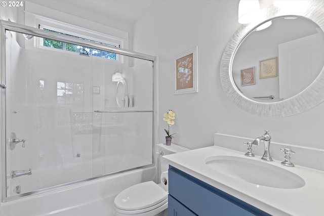 full bathroom with toilet, vanity, and bath / shower combo with glass door