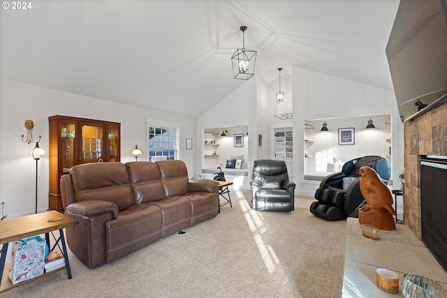 carpeted living room featuring a notable chandelier, a stone fireplace, and high vaulted ceiling