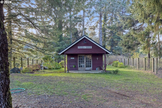 view of front of property with french doors and a front lawn