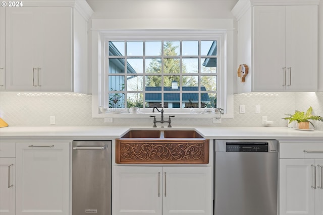 kitchen with stainless steel dishwasher, white cabinetry, tasteful backsplash, and sink