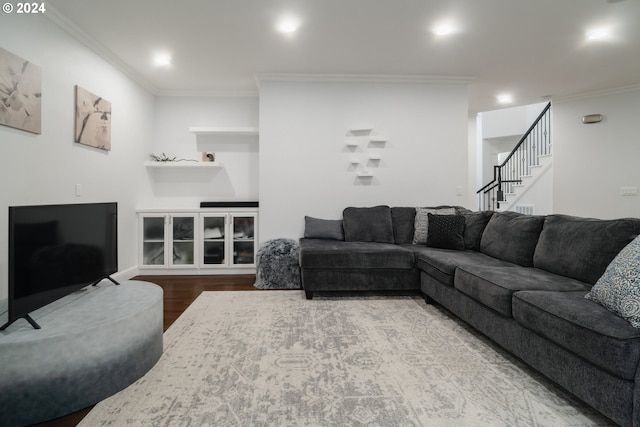 living room featuring ornamental molding and wood-type flooring