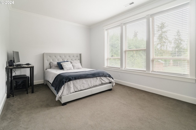 bedroom with ornamental molding and carpet flooring