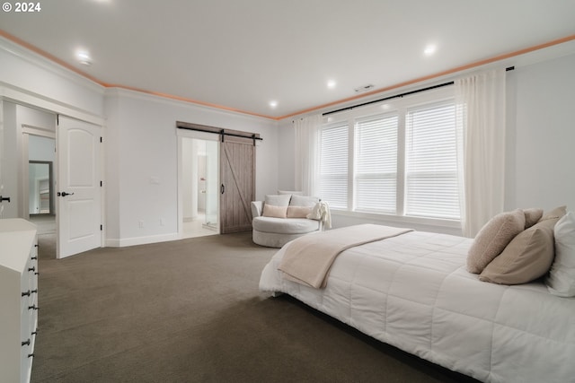 bedroom with a barn door, dark colored carpet, and crown molding