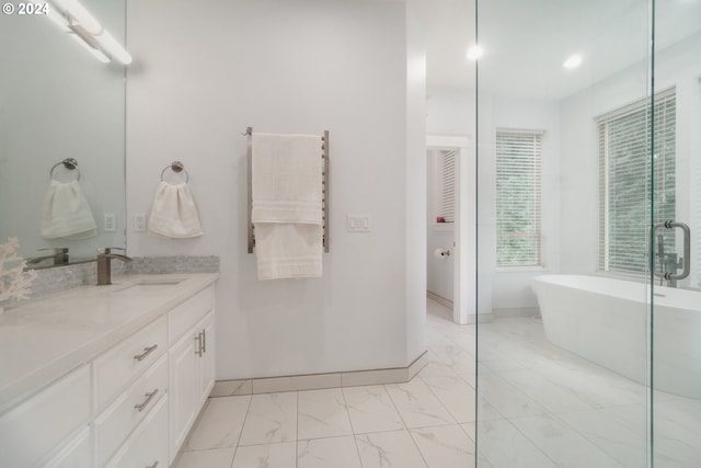 bathroom featuring separate shower and tub and vanity