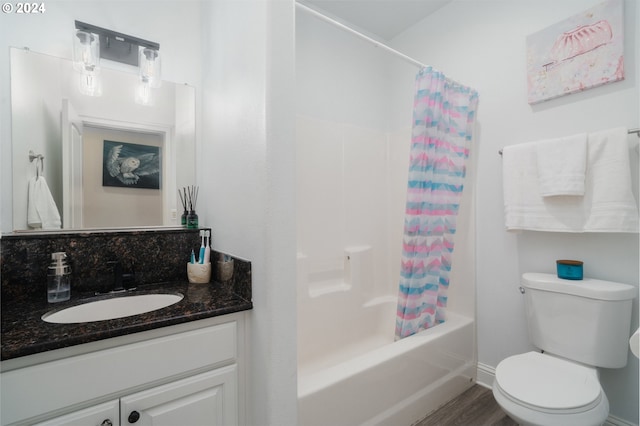 full bathroom featuring vanity, toilet, wood-type flooring, and shower / bath combo with shower curtain