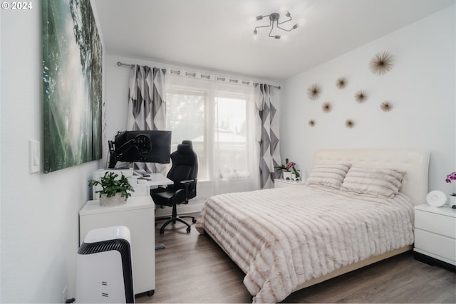 bedroom with hardwood / wood-style floors