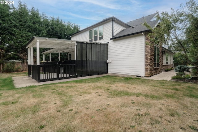 back of house featuring a yard, a patio, and a pergola