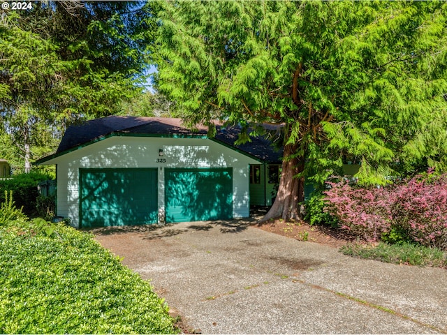 view of outbuilding featuring driveway and a garage