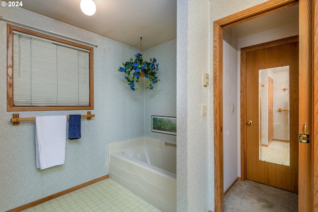 full bathroom featuring tile patterned floors, baseboards, and a bath