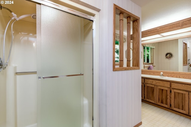 bathroom featuring a stall shower, vanity, and tile patterned floors