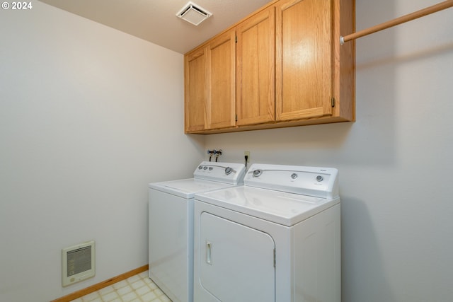 laundry room featuring heating unit, light floors, cabinet space, visible vents, and washer and dryer