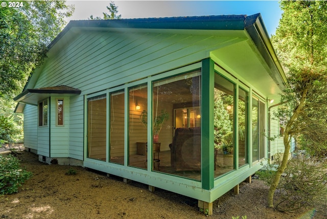 view of side of property featuring a sunroom