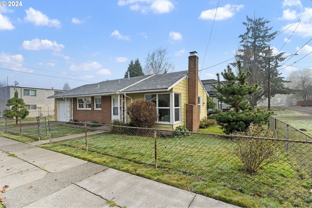 ranch-style home with a front lawn