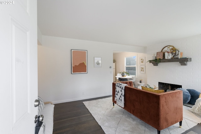 living room with light hardwood / wood-style flooring and a brick fireplace