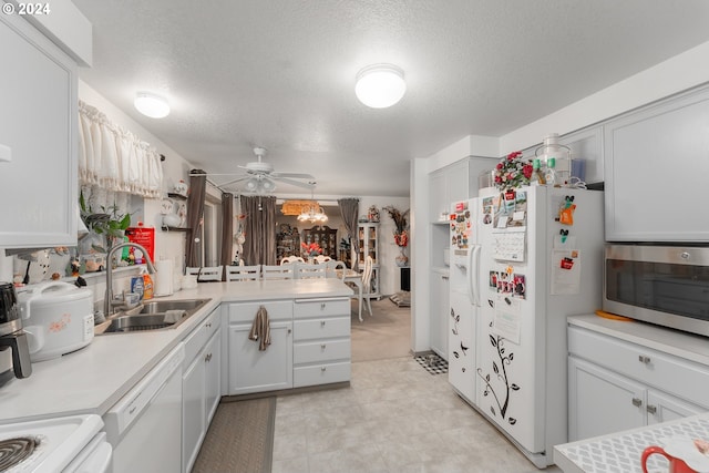 681 Hamlin Dr, Canyonville, OR 97417 - kitchen with a sink, white appliances, a ceiling fan, a peninsula, and light countertops