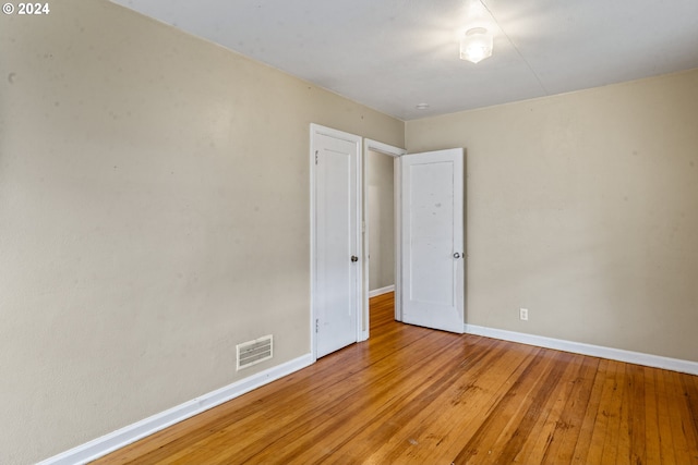 spare room with light hardwood / wood-style flooring