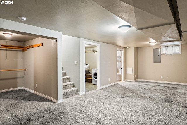 basement featuring carpet, washer / dryer, and electric panel