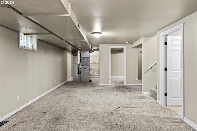 basement featuring light carpet and heating unit