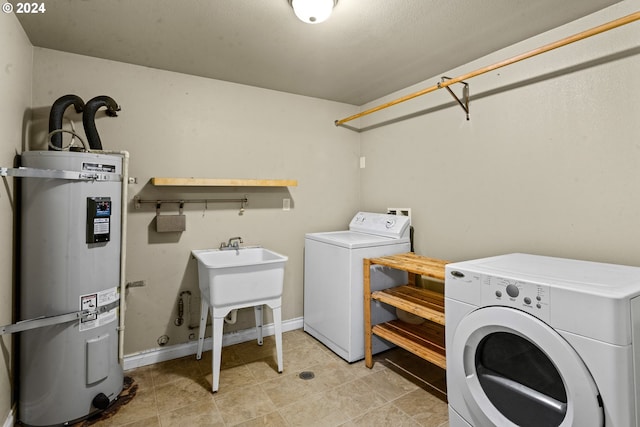 laundry room with separate washer and dryer, water heater, and light tile patterned floors