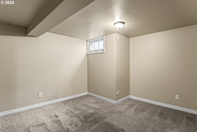 additional living space with beam ceiling, carpet, and a textured ceiling