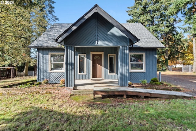 bungalow-style home featuring a front yard