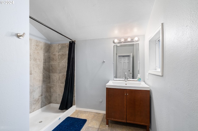 bathroom featuring vanity, a textured ceiling, and curtained shower