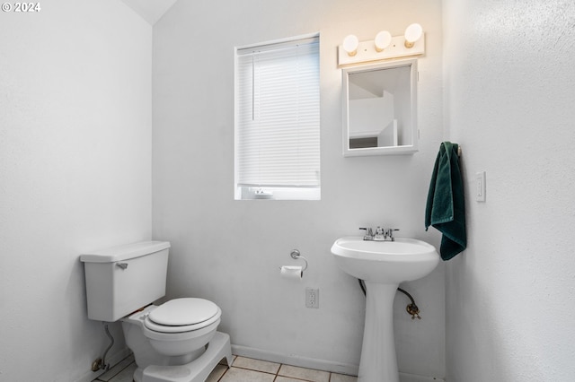 bathroom with toilet and tile patterned floors