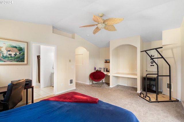 bedroom featuring connected bathroom, lofted ceiling, light carpet, and ceiling fan