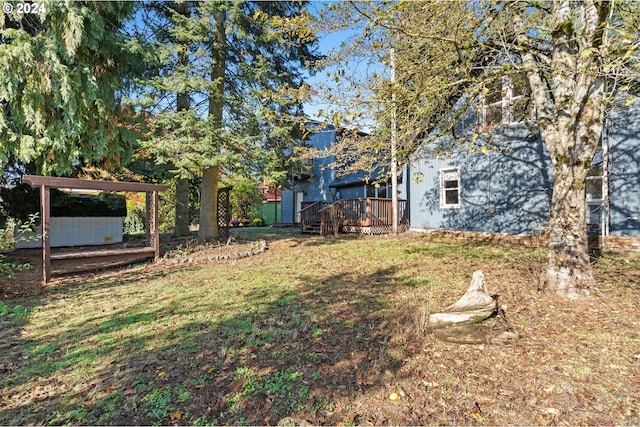 view of yard featuring a wooden deck