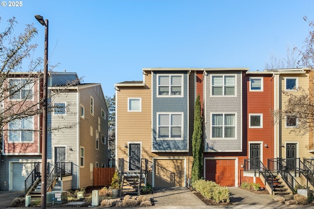 townhome / multi-family property with concrete driveway and an attached garage