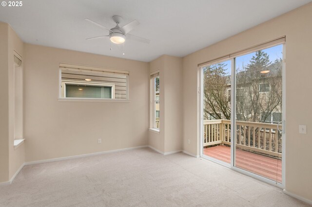 carpeted spare room with baseboards, visible vents, ceiling fan, and vaulted ceiling