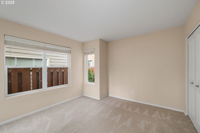 carpeted spare room with baseboards