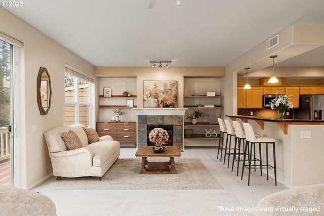 kitchen featuring visible vents, dark countertops, light wood-type flooring, a sink, and stainless steel appliances