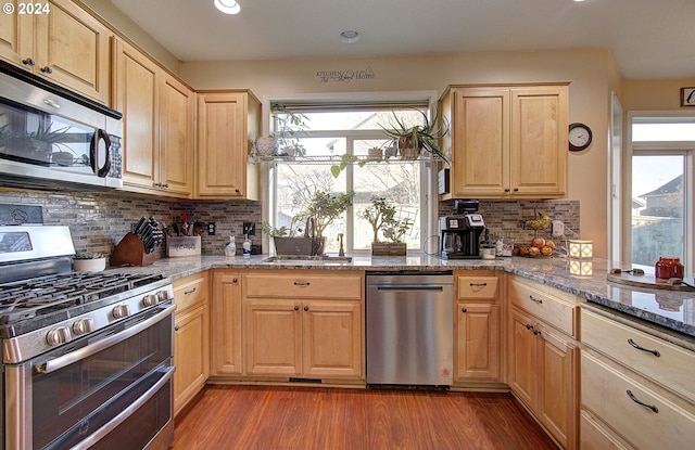 kitchen featuring decorative backsplash, light brown cabinetry, dark hardwood / wood-style floors, and appliances with stainless steel finishes