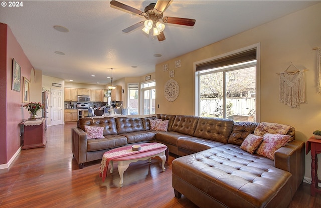 dining area with a textured ceiling, ceiling fan, and dark hardwood / wood-style floors