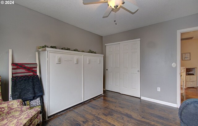 office space with dark hardwood / wood-style floors, ceiling fan, and a textured ceiling