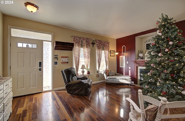 entrance foyer featuring dark hardwood / wood-style flooring and a textured ceiling