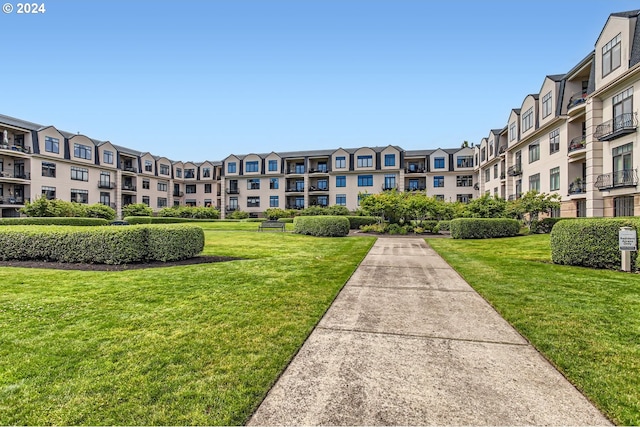 view of property's community featuring a yard