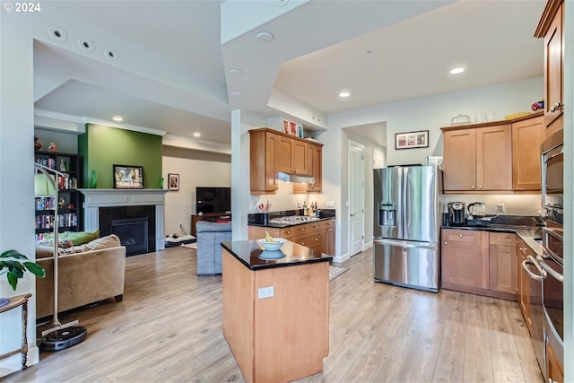 707 N Hayden Island Dr Unit 301, Portland, OR 97217 - kitchen with stainless steel appliances, dark countertops, light wood finished floors, under cabinet range hood, and open floor plan
