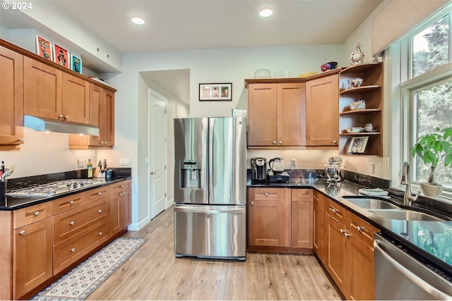 707 N Hayden Island Dr Unit 301, Portland, OR 97217 - kitchen with stainless steel appliances, under cabinet range hood, a sink, open shelves, and light wood-type flooring
