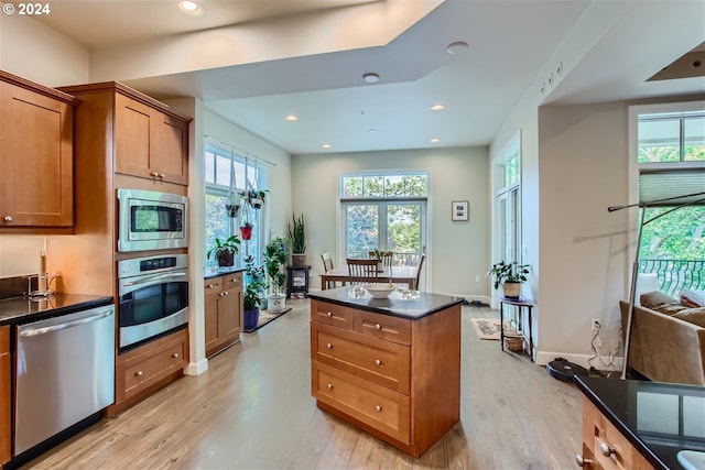 707 N Hayden Island Dr Unit 301, Portland, OR 97217 - kitchen with appliances with stainless steel finishes, light wood-style flooring, plenty of natural light, brown cabinets, and recessed lighting