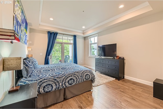 707 N Hayden Island Dr Unit 301, Portland, OR 97217 - bedroom featuring a raised ceiling, access to exterior, hardwood / wood-style flooring, crown molding, and baseboards