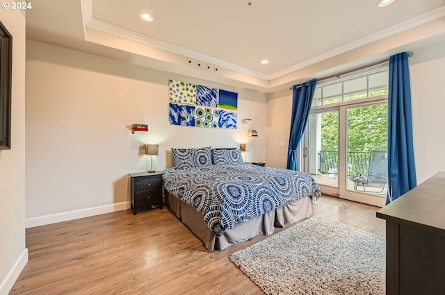 707 N Hayden Island Dr Unit 301, Portland, OR 97217 - bedroom featuring ornamental molding, access to exterior, light wood-type flooring, baseboards, and a raised ceiling