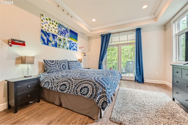 707 N Hayden Island Dr Unit 301, Portland, OR 97217 - bedroom featuring access to exterior, a tray ceiling, wood finished floors, baseboards, and crown molding
