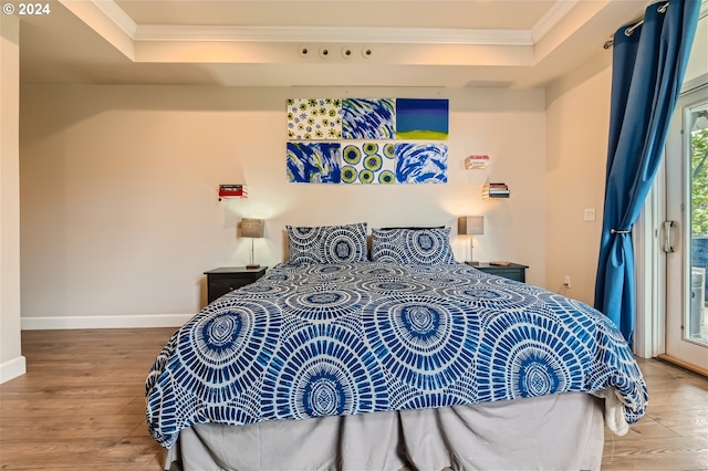 707 N Hayden Island Dr Unit 301, Portland, OR 97217 - bedroom with ornamental molding, a raised ceiling, wood finished floors, and access to exterior
