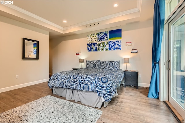 707 N Hayden Island Dr Unit 301, Portland, OR 97217 - bedroom featuring crown molding, a tray ceiling, wood finished floors, baseboards, and recessed lighting