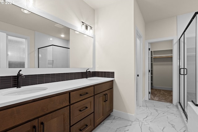 bathroom with tasteful backsplash, vanity, and an enclosed shower