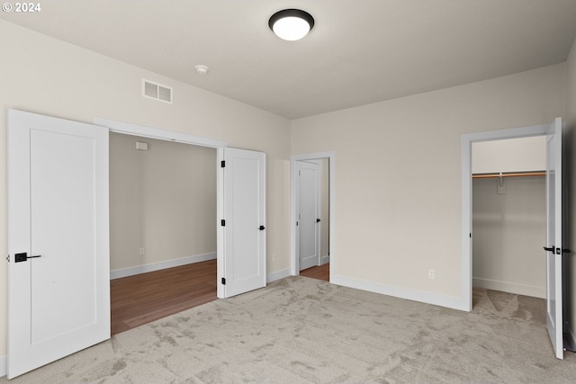 kitchen with cream cabinetry, double wall oven, light hardwood / wood-style flooring, and backsplash